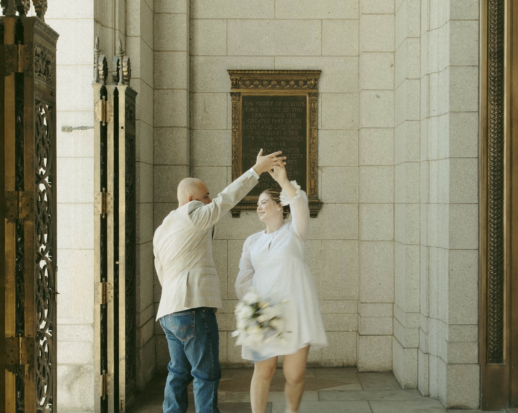 Happy couple dancing at their urban elopement in downtown St. Louis, captured with a nostalgic film aesthetic by Stacey Vandas Photography.