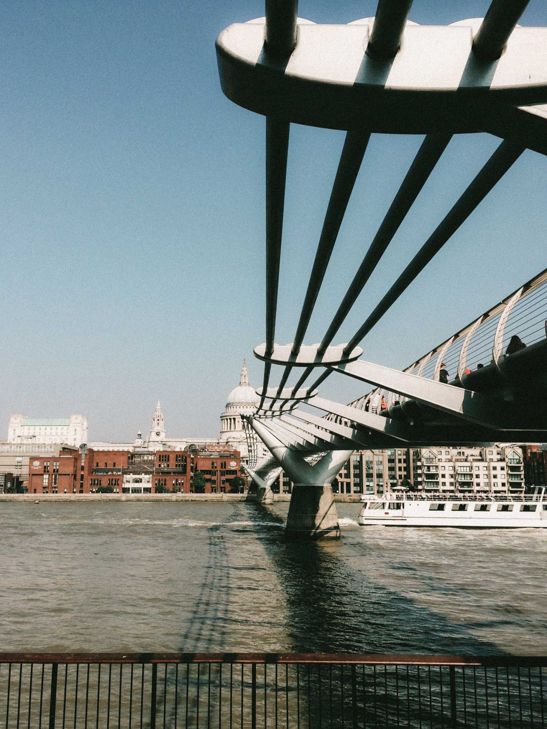 A view of the Millennium Bridge, the Thames River, and St. Paul's Cathedral in London, England.