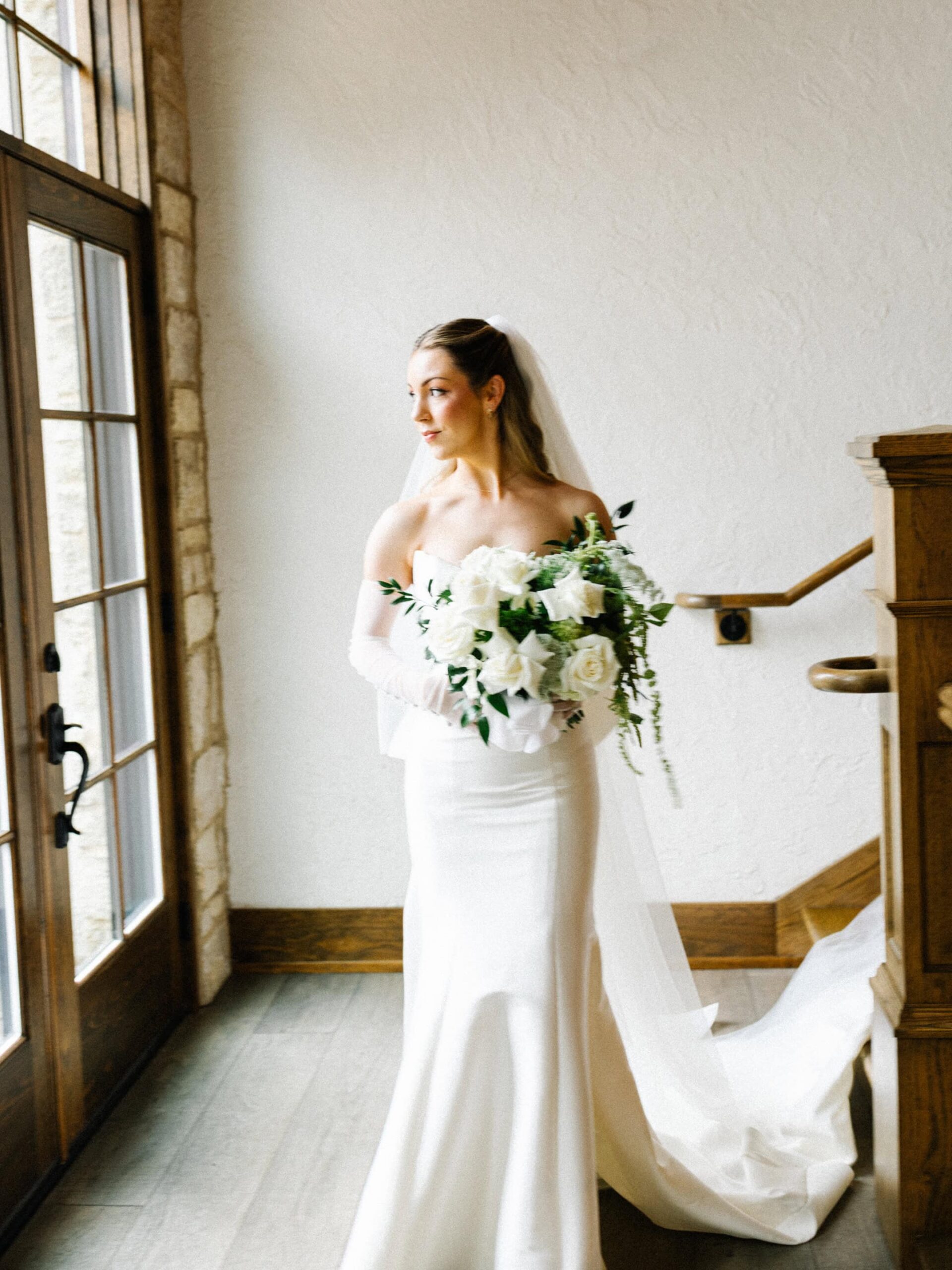 A blurry, documentary-style image of a bride walking with her bouquet edited with a film aesthetic.