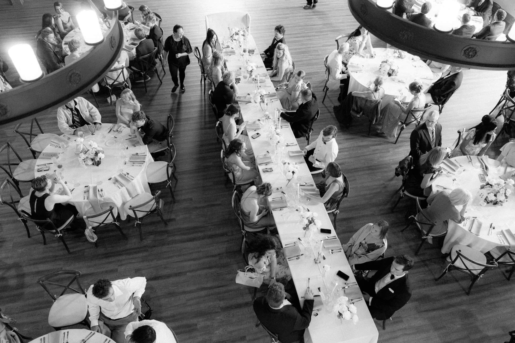 An overhead view of a wedding reception in black and white.