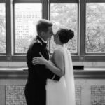 A blurry, out of focus silhouette of a bride and groom in front of a window in a historic Chicago wedding venue.