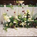 A sculptural floral arrangement in a modern green palette.